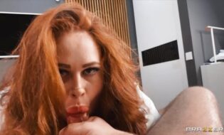 A voluptuous redhead mounts a massive member